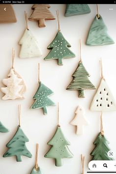 ceramic christmas trees are hanging on the wall