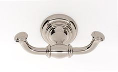 a chrome toilet paper holder on a white wall with two handles and one handrail