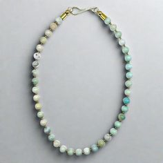 This beaded necklace features pale blue colors of amazonite round beads alternating with 2mm gold plated brass spacers. This piece is finished with a gold plated brass hook. This is a perfect piece for a #neckmess. Length: 18" 8mm Amazonite round beads 2mm Gold plated brass spacer beads Handmade in Lincoln, Nebraska Handmade Amazonite Round Beads Necklaces, Gold Single Strand Amazonite Beaded Necklace, Gold Single Strand Beaded Necklace With Amazonite, Single Strand Amazonite Spiritual Beaded Necklace, Adjustable Single Strand Amazonite Beaded Necklace, Light Blue Single Strand Necklace With Round Beads, Handmade Gold Amazonite Necklaces, Handmade Gold Amazonite Necklace, Beaded Collar Necklace