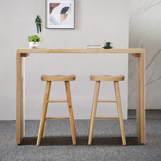 two wooden stools sitting under a table