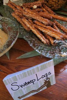 there are many different types of food on the table, including pretzels and other snacks