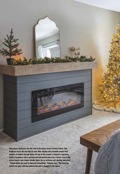 a living room with a christmas tree in the corner and a fire place on the wall