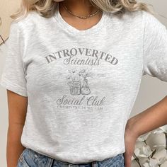 a woman wearing a white t - shirt with the words, introed scientist social club on it