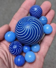 a hand holding some blue balls in it