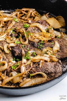 steak with onions and mushrooms in a skillet