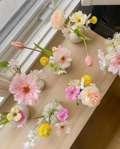 flowers are arranged in vases sitting on a window sill next to the windowsill