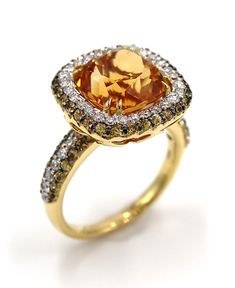 Vanna K 18K yellow gold ring with round diamonds totaling 0.55 carats, round yellow sapphires totaling 0.80 carats and one citrine center stone totaling 4.95 carats. 💕 We're shipping daily! ✈️ Choose free shipping at checkout ☎️ Call 201-722-0216 with questions 🌈 Massoyan Jewelers since 1993 💭 Chat with us live! Bottom right corner of your screen Orange Topaz Ring With Diamond Center Stone, Orange Diamond Topaz Ring With Center Stone, Elegant Yellow Halo Ring With Center Stone, Fine Jewelry Yellow Topaz Ring With Halo Setting, Yellow Topaz Halo Ring Fine Jewelry, Formal Yellow Topaz Ring With Diamond Accents, Yellow Topaz Ring With Halo Setting, Elegant Yellow Topaz Ring Round Cut, Yellow Gold Citrine Diamond Ring With Accent Stones