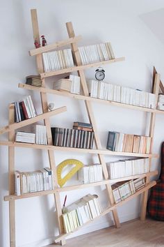 a bookshelf made out of wooden planks in the corner of a room