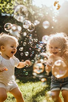 two young children playing with bubbles in the grass