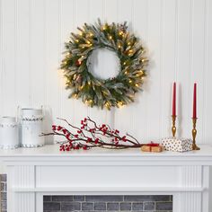 a christmas wreath is hanging on the fireplace mantel