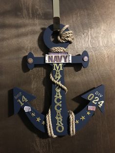 a navy anchor with rope hanging from it