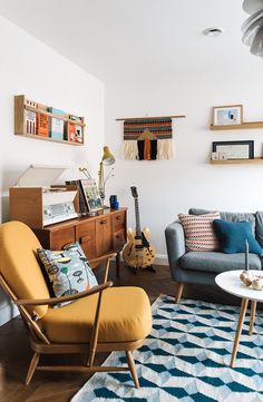 an image of a living room with furniture and pictures on the wall above it that says photo