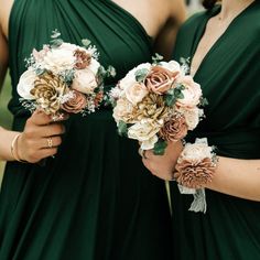 two bridesmaids in green dresses holding bouquets