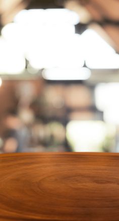 a wooden table top with blurry background