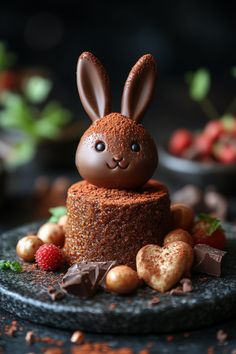 there is a chocolate cake with bunny ears on top and nuts around the edges, as well as strawberries