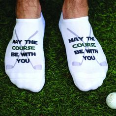 a man's feet with socks that say, may the course be with you