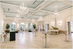 a large room with chandeliers and tables in it