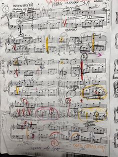 an old sheet with music notes written in red, yellow and blue ink on it