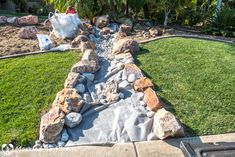 an outdoor garden with rocks and grass