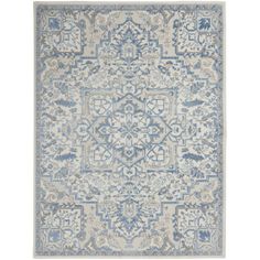 a blue and white rug with an intricate design on the bottom, in front of a white background