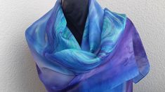 This original abstract scarf is perfect for this season! The blue scarf has an abstract design with lines and spirals in light mint color. The floating soft lines make the scarf an elegant accessory. I draw it freehand by brush and that makes the scarf really unique. The silk is soft and has a luxurious feel that the photos just can't reveal. Unique scarf/ shawl is - hand painted with professional steam fixed dyes on 100% silk pongée 5 - colors : blue, purple, green - 18''x 71"/ 45x 180cm Purple Formal Purple Silk Scarves, Purple Silk Scarf Long, Luxury Purple Silk Scarf For Women, Abstract Scarf, Purple Shawl, Purple Silk Scarf, Unique Scarf, Blue Silk Scarf, Purple Scarf