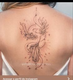 the back of a woman's neck with a bird tattoo on it