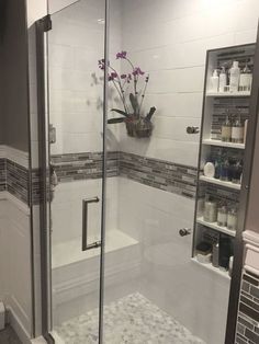 a walk in shower sitting next to a bathroom sink