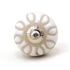 a white and gold decorative knob on a white background