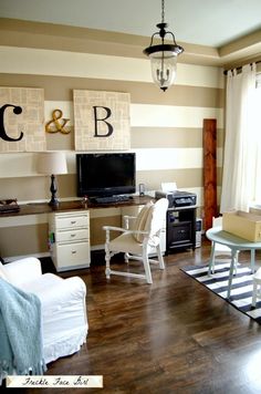 a living room filled with furniture and a flat screen tv on top of a wooden floor