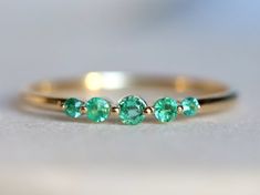 Emerald ring, Stacking ring, Emerald stacking ring, 5 stone ring, Emerald stacking ring, dainty emerald ring, dainty ring, May birthstone Same design can be made also with other custom gemstones per request. Product details:- Solid gold- approx 2.5, 2, 1.5mm emerald - Band size is 1.2mmRing size - US 3 to US 9 (for smaller or larger ring size, please contact)Please select your size at the drop down menu. All orders will be shipped via DHL or FedEx express shipping.Thanks! Everyday Diamond Ring, Minimal Diamond Ring, Aquamarine Stacking Ring, 5 Stone Ring, Grey Diamond Ring, Emerald Band, Raw Diamond Engagement Rings, Smaragd Ring, Rough Diamond Ring