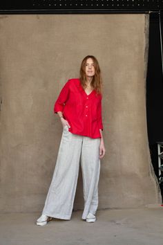 "A stylish oversize shirt with practical ¾ sleeves ended with cuffs. The shirt is designed to have a relaxed fit having a casual collarless silhouette. A dainty V-neck elongates the length of the neck. The shirt is decorated with big front pockets and nice noteworthy organic coconut buttons. The garment can be perfectly combined with various types of pants whether you prefer skinny or wide-leg designs. DETAILS ⚬ Decorated with handmade stitches. ⚬ V-neck. ⚬ Chest patch pockets. ⚬ 3/4 sleeves. ⚬ Oversized Half Sleeve Blouse For Work, 3/4 Sleeve Relaxed Fit Shirt For Daywear, Relaxed Fit Shirt With 3/4 Sleeves For Daywear, 3/4 Sleeve Shirt With Relaxed Fit, Relaxed Fit Blouse With Button Cuffs For Casual Gatherings, Elegant Half Sleeve Relaxed Fit Blouse, Red Linen Relaxed Fit Shirt, Red Linen Shirt With Relaxed Fit, Red Linen Shirt Relaxed Fit