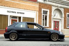 a black car parked in front of a building