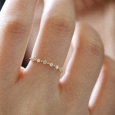 a woman's hand with a diamond ring on it