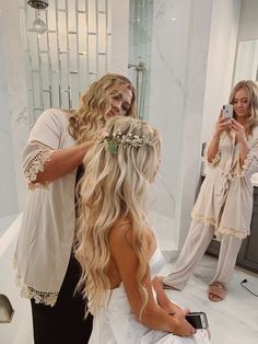 the bride is getting ready for her big day in the bathroom with her hair and make up done