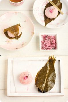 there are plates with food on them and one has a leaf in the shape of a heart