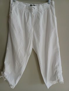 Classic white cotton pants. Length 29", inseam 20", rise 10" elastic waist 13-18" with two side pockets Small spot (hard to notice) Thank you Smoke Free Home Cats at Home White Cotton Pants For Spring, White Cotton Ankle-length Pants, White Ankle-length Cotton Pants, White Stretch Capri Bottoms, White Cotton Lounge Pants, White Stretch Cotton Capris, Casual White Capri Pants, White Cotton Capris, White Cotton Trousers