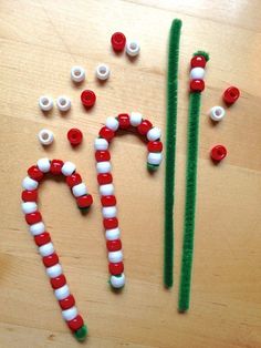 some candy canes are sitting on a table with pins in the shape of letters