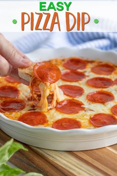 a person taking a slice of pizza from a white casserole dish