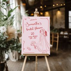 a pink sign sitting on top of a wooden easel