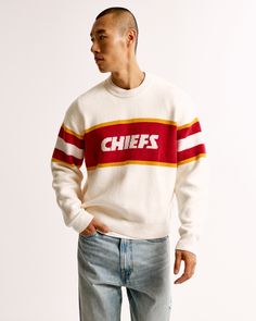 NFL Kansas City Chiefs sweater in our soft sweater-knit fabric and oversized-fit silhouette, featuring a slightly cropped body length, Kansas City Chiefs script graphic logo detail at chest, arm band details, crew neckline and banded hem and cuffs. Nfl Kansas City Chiefs, Baggy Clothes, Ecco Shoes, Men's Tops, Graphic Logo, Soft Sweater, Abercrombie And Fitch, New York Jets, Christmas 2024