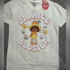 Strawberry Shortcake Size Small Graphic Tee Orange Blossom White Retro Shirt For Spring, Cute White T-shirt For Spring, Cute White Shirt With Floral Print, Cute Cotton Shirt For Spring, Cute Graphic Print Shirt For Spring, Cute Relaxed Fit Shirt For Spring, Sweet Crew Neck Top For Spring, Sweet Cotton Shirt For Spring, Cute Orange Cotton Shirt