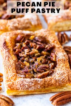 several pecan pies on a white surface with nuts scattered around them and one is cut in half to show the filling