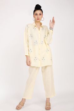 Buttercup linen shirt with floral embroidery.
Component: 1
Pattern: Embroidery
Type Of Work: Floral
Neckline: Shirt collar
Sleeve Type: Long sleeves
Fabric: Linen
Color: Yellow
Other Details: 
Front button detailing
Note: Pant worn by the model is not for sale
Occasion: Work - Aza Fashions Floral Embroidered Shirt, Collar For Women, Linen Embroidery, Buy Linen, Linen Color, Embroidery Floral, Pattern Embroidery, Yellow Top, Collars For Women