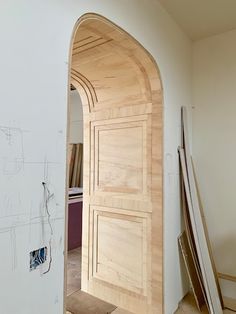 an arch in the wall is being built to look like it's made out of wood