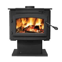 a black stove with flames in it on top of a stand next to a toothbrush