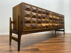 a large wooden cabinet sitting on top of a hard wood floor