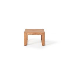 a small wooden table sitting on top of a white floor with no one around it