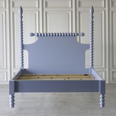 a blue bed frame with wooden slats