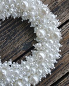 a wreath made out of pearls on top of a wooden table