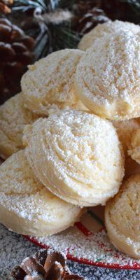 a pile of powdered sugar cookies sitting on top of a red and white plate